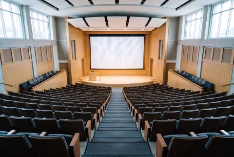 Tiered lecture hall, wide establishing shot — Landing page imagery, academics hero.